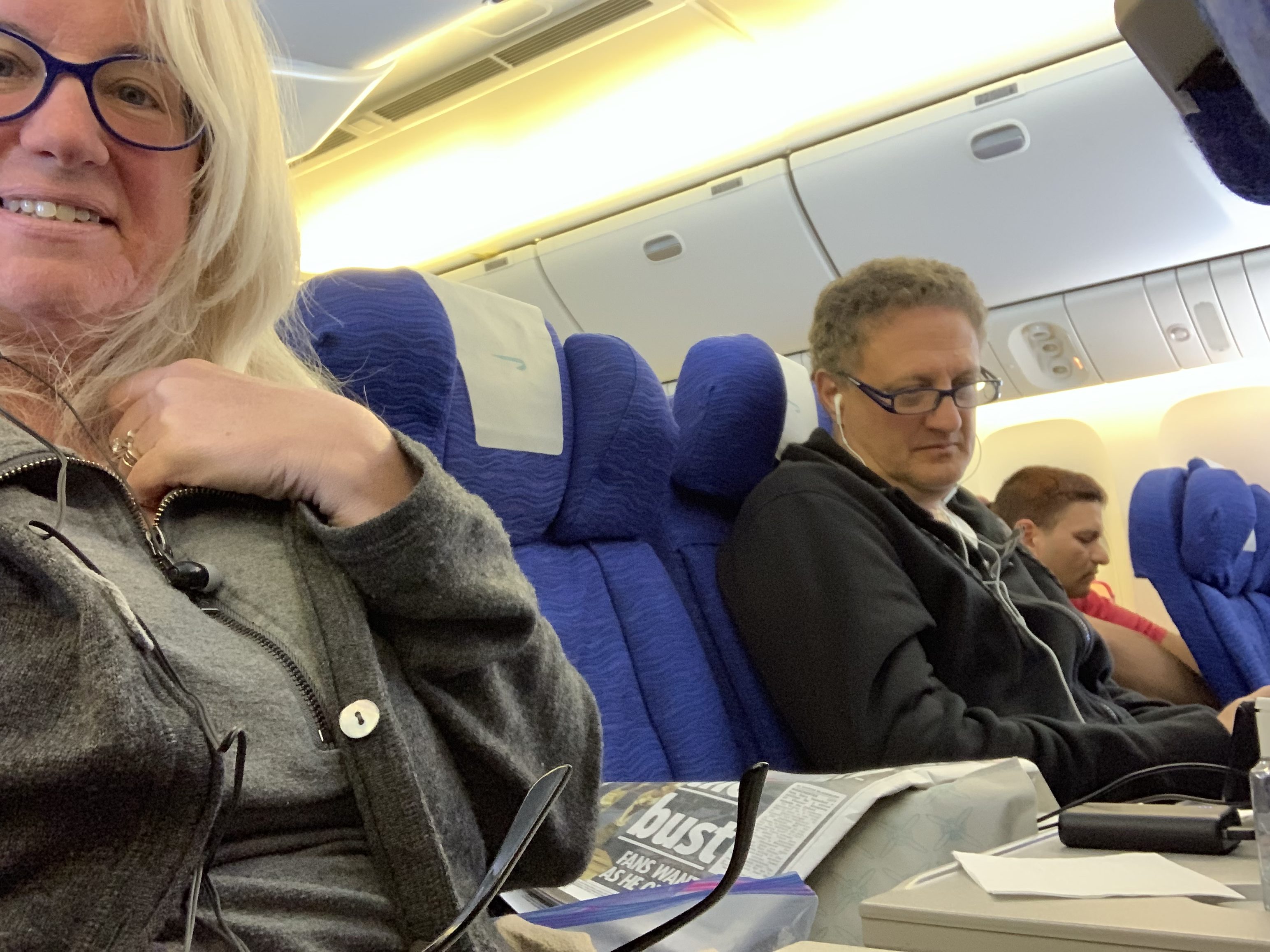 Airplane Passengers With An Empty Seat Between Them